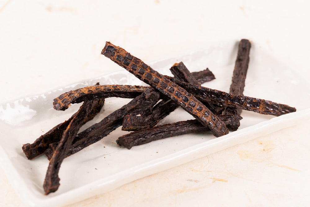 Close-up of Air Dried Tuna Minced Sticks showing the natural texture of this tuna dog treats. High in taurine, DHA and EPA, a healthy air-dried treat from Michinoku Farm Japan